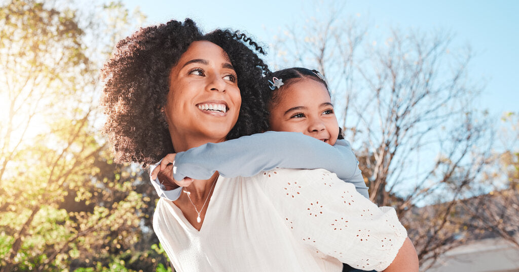 Mother and daughter outdoors in Florida during autumn, enjoying the sunshine while highlighting the need for sun protection in September, October, and November.