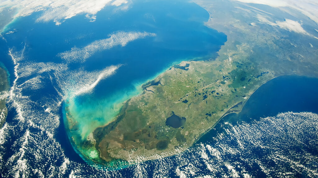 Satellite view of the Florida peninsula surrounded by the Atlantic Ocean and Gulf of Mexico, illustrating Florida’s geography and year-round sun exposure featured in a city-by-city guide to Florida weather and UV Index levels.