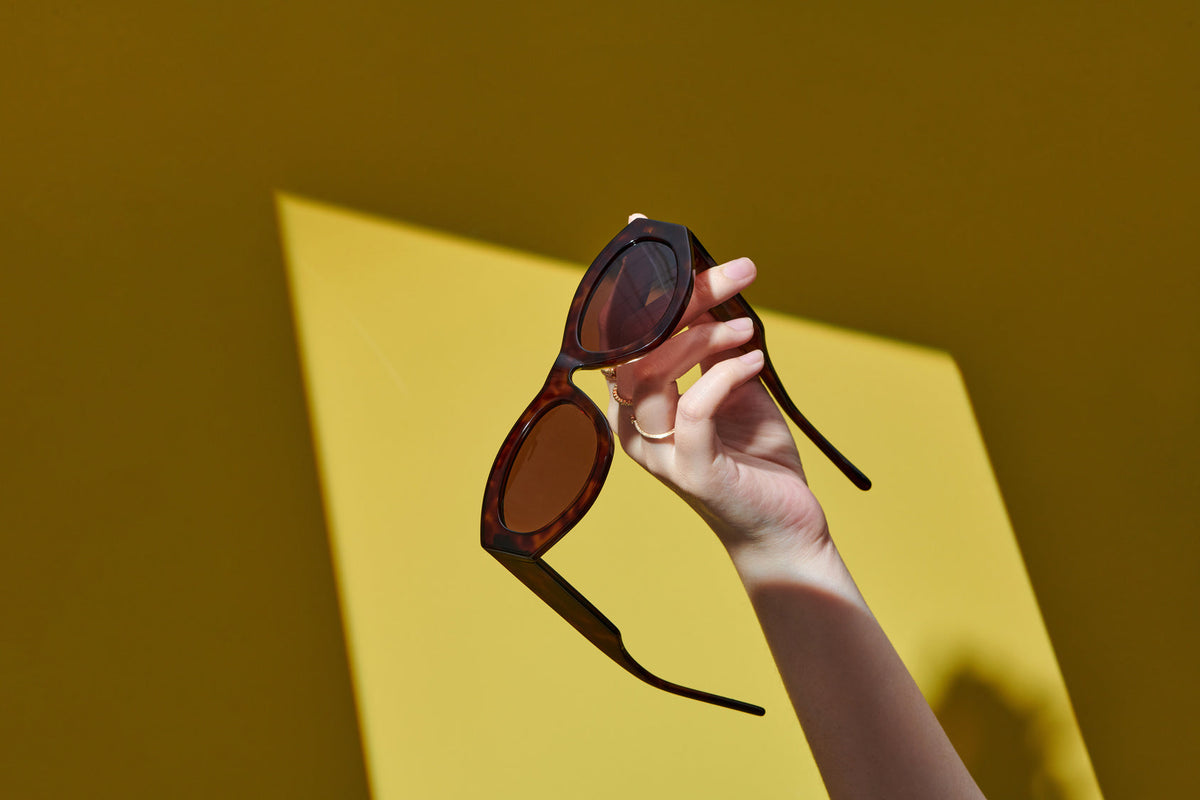 Close-up of sunglasses in sunlight, emphasizing how UV-protective lenses help block harmful UV rays and protect eye health.